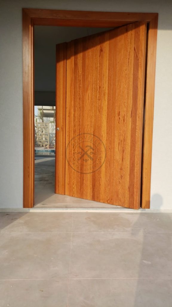 Porta pivotante de lambril de Angelin Pedra com puxador cava na própria madeira - Imagem 4