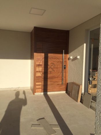 Porta pivotante de lambril maciço com painéis e bandeira seguindo o mesmo alinhamento da porta - Imagem 3