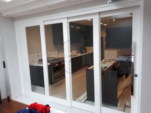 Porta com sistema de correr embutido sobrepostas com vidro panorâmico incolor - Imagem 5