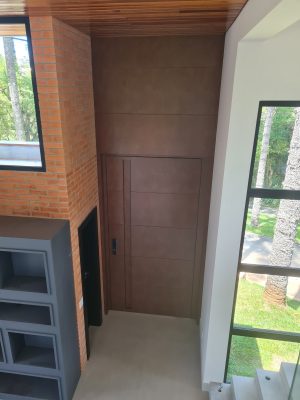 Porta pivotante em ACM aço corten com frisos horizontais, puxador cava e dupla vedação - Imagem 12