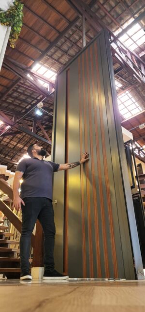 Porta em ACM Dark Grey com detalhes em Mogno, puxador cava, dupla vedação porta e batente