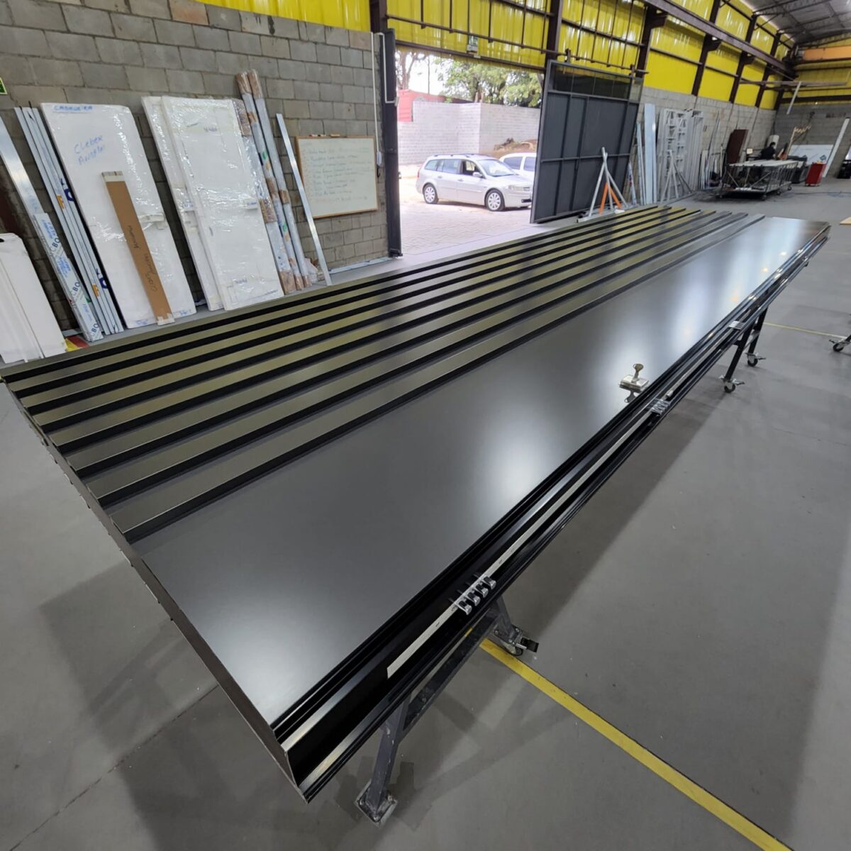 Porta pivotante em ACM ripado na vertical cor Dark Grey e dupla vedação - Imagem 7